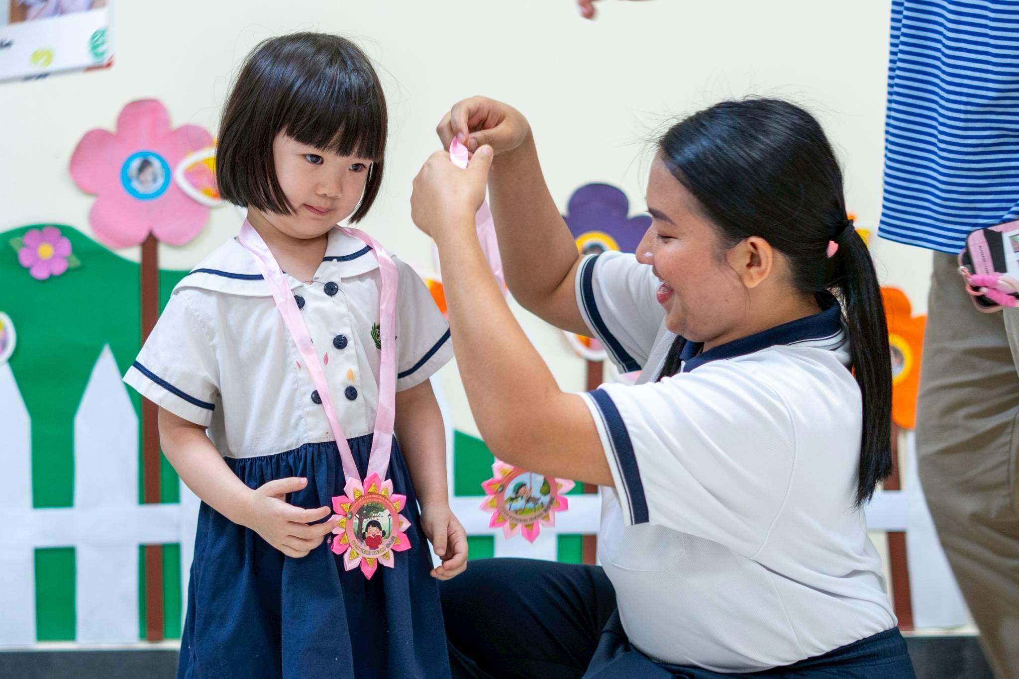 Shazia Jolie Ong receives her Kind Hearted Award for being a great friend to her classmates, and Brave Explorer Award for overcoming shyness and trying new things. 