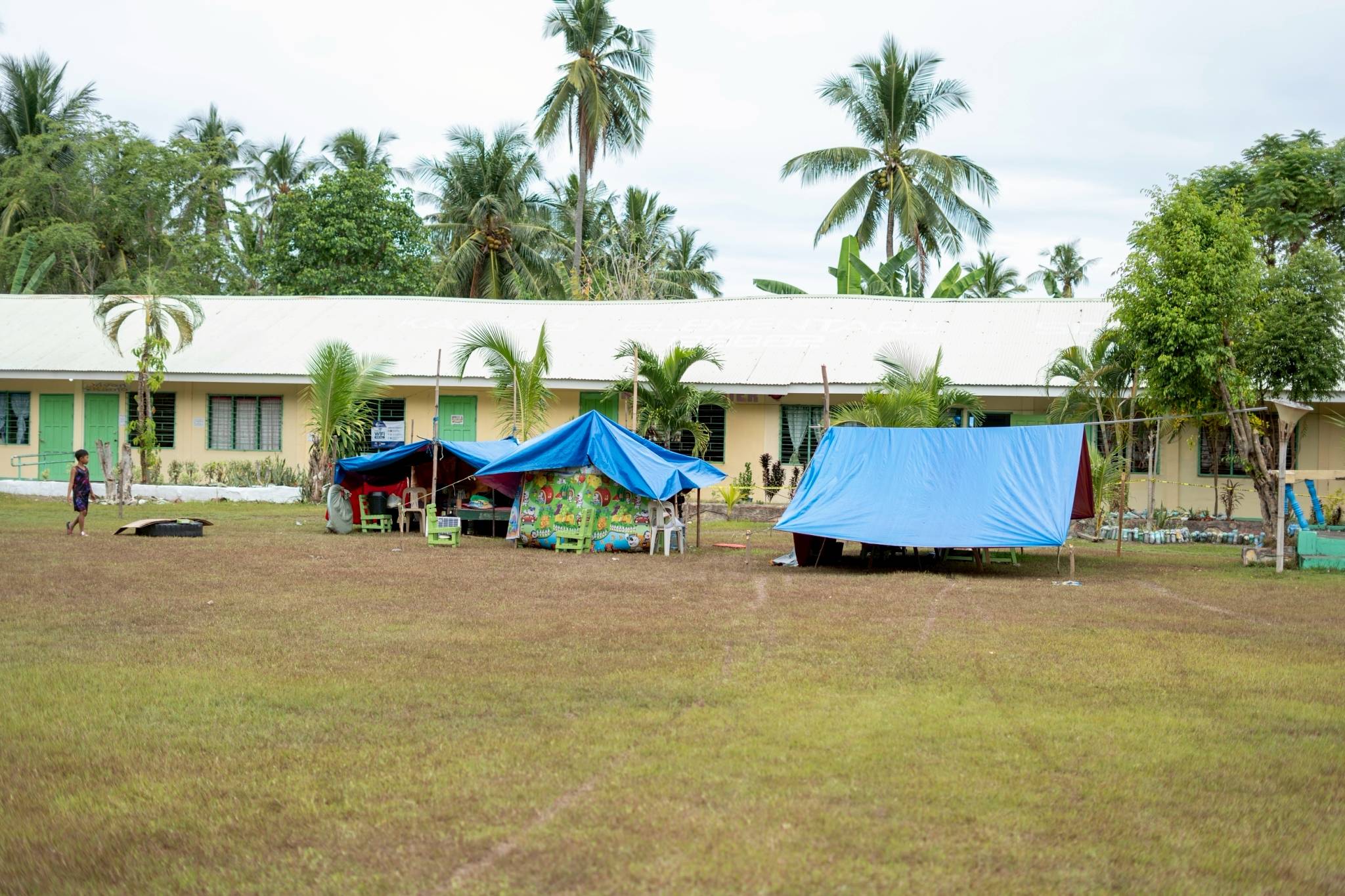 Tents serve as a temporary shelter for families who lost their homes. Yet when it rains, they still have to seek dry areas to sit and lay down. 