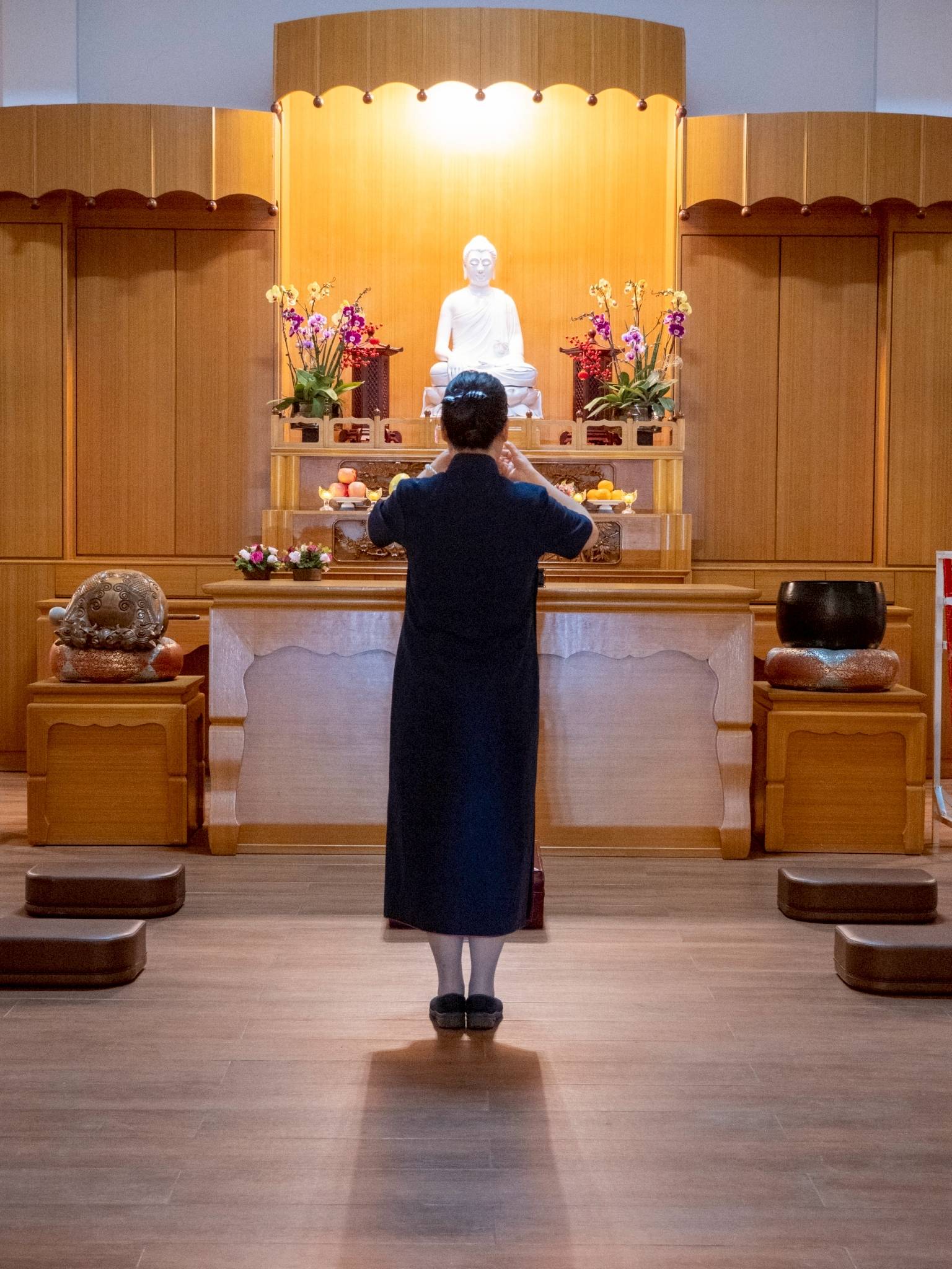 In quiet reverence, the sacred flower and light offering ceremony takes place inside the Jing Si Abode.