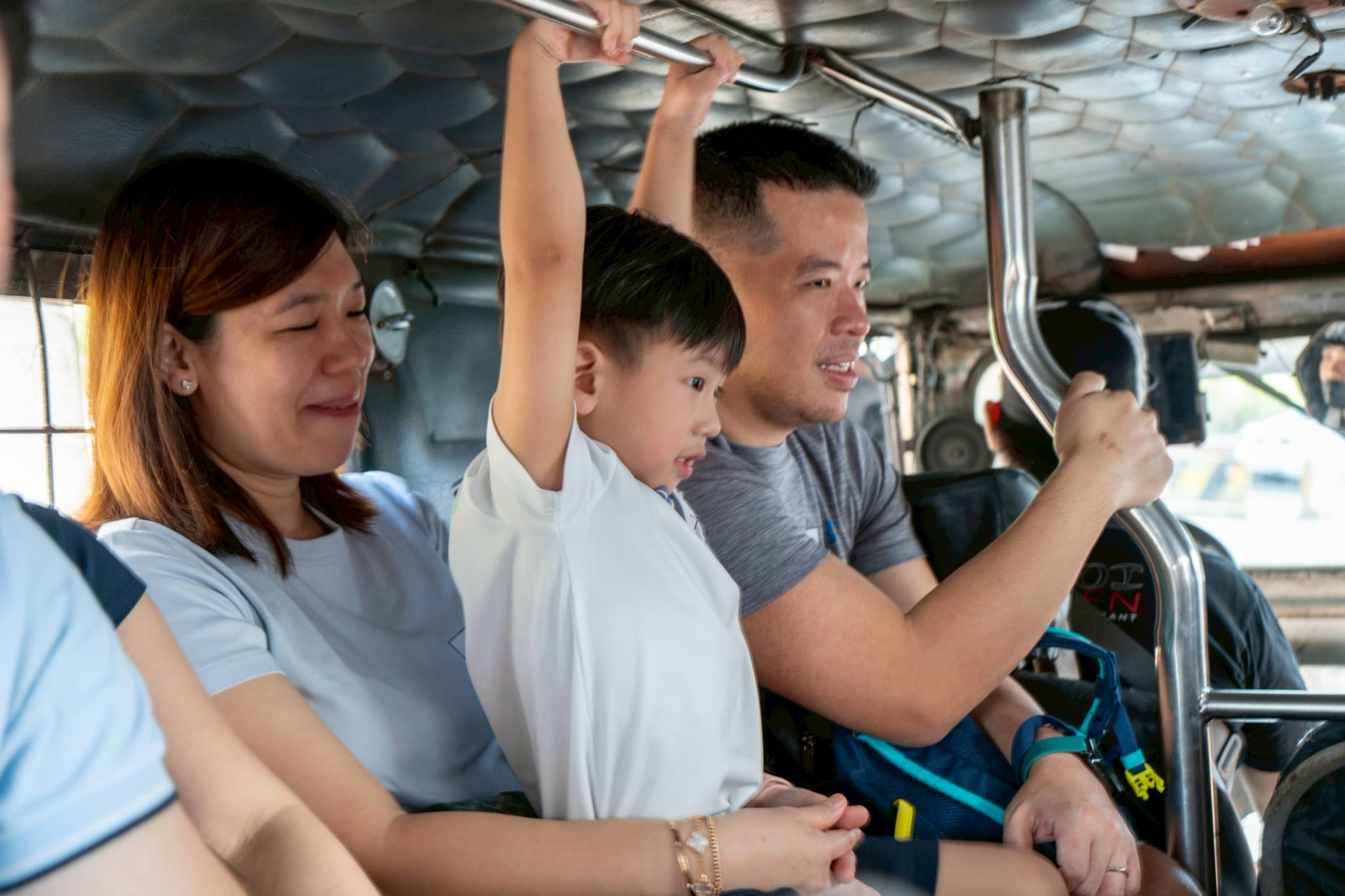 The children took extra precautions by holding the handrails throughout the ride.