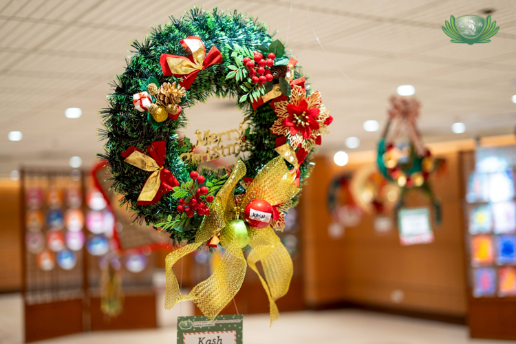 Wreaths created by nursery students were hung around the hall, showcasing their hard work and creativity.