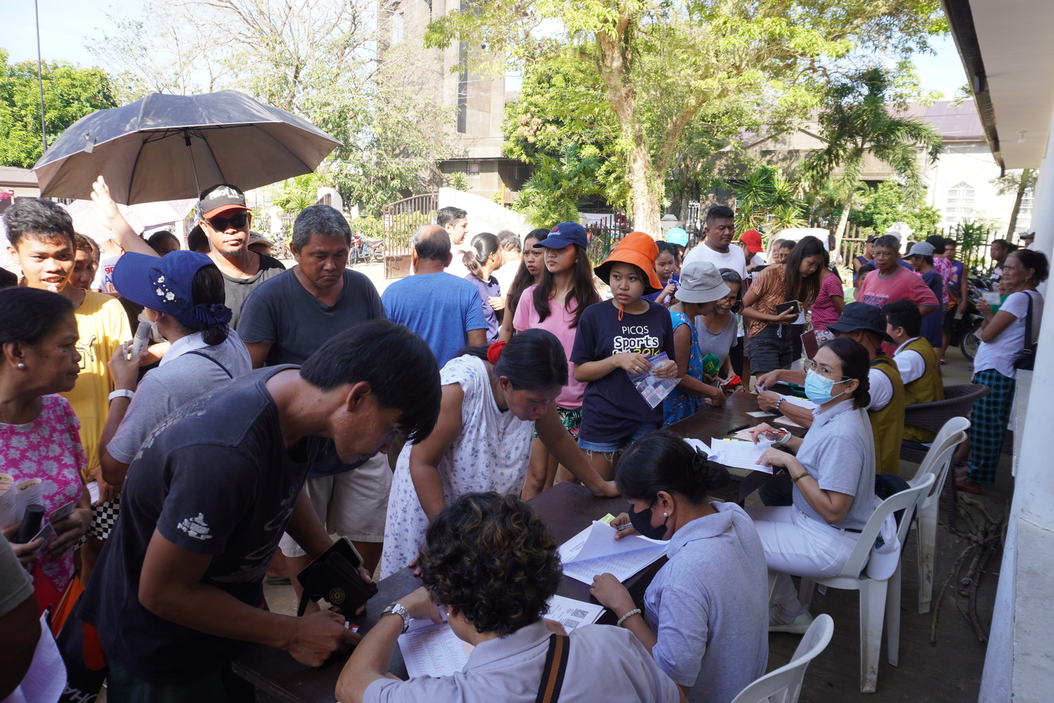 Volunteers distribute relief stubs for the affected families of Typhoon Kristine (Trami).