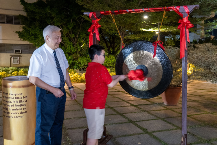 Fostering inclusivity, CEO Yuñez invites guests of all ages, including children, to participate in striking the traditional gong.