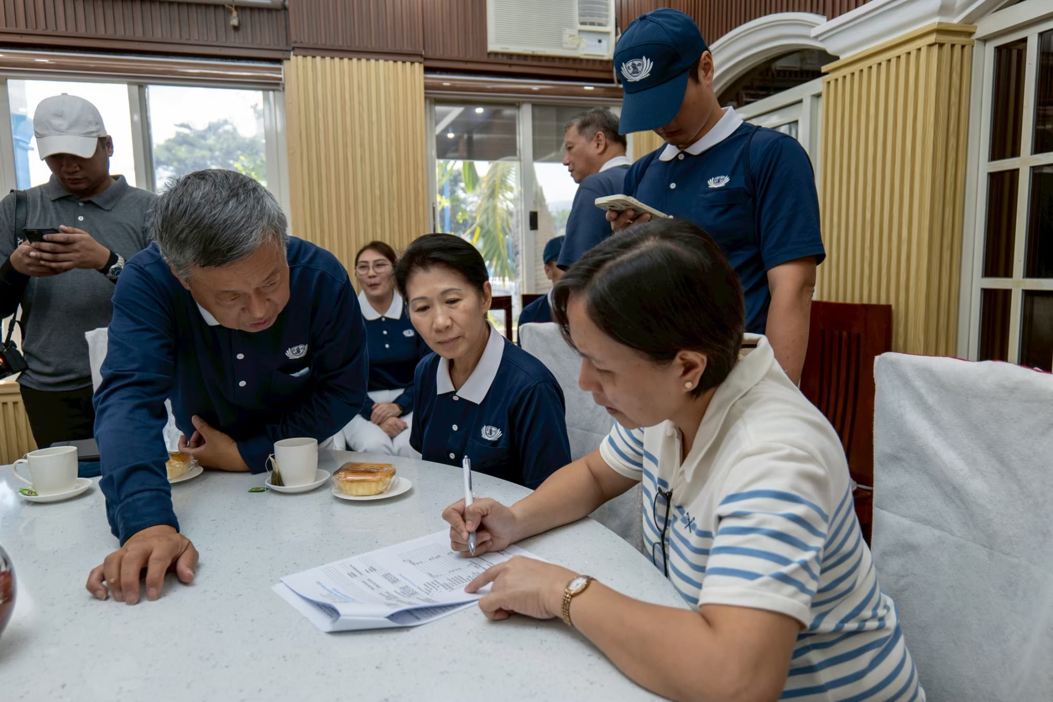 Conferring with Mayor Aurora Guzman Taay of Dingalan (right) during an ocular visit after Typhoon Uwan (Fung-Wong). 