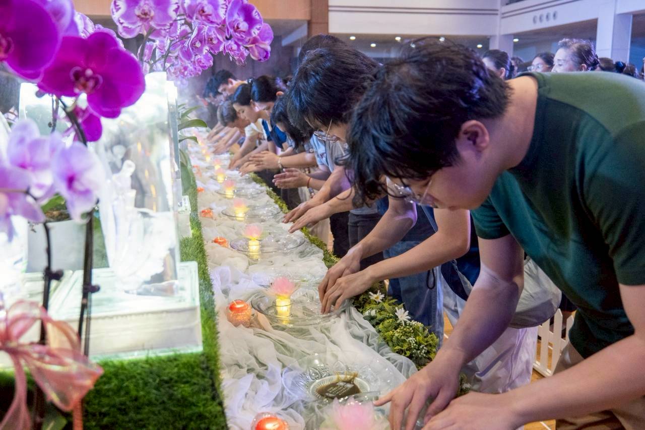 Visitors take part in the Buddha Bathing Ceremony. 