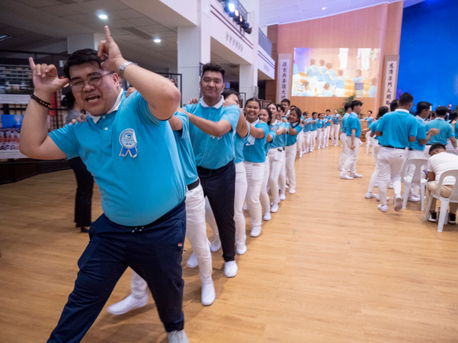 2024 Camp Head and Tzu Chi scholar Paolo Nicole Santos (first in line) leads fellow scholars in a spirited song and dance of Tzu Chi’s “Pulling the Ox Cart.” He hopes future batches of scholars will be given a chance to organize succeeding camps “as a way to pay it forward.”