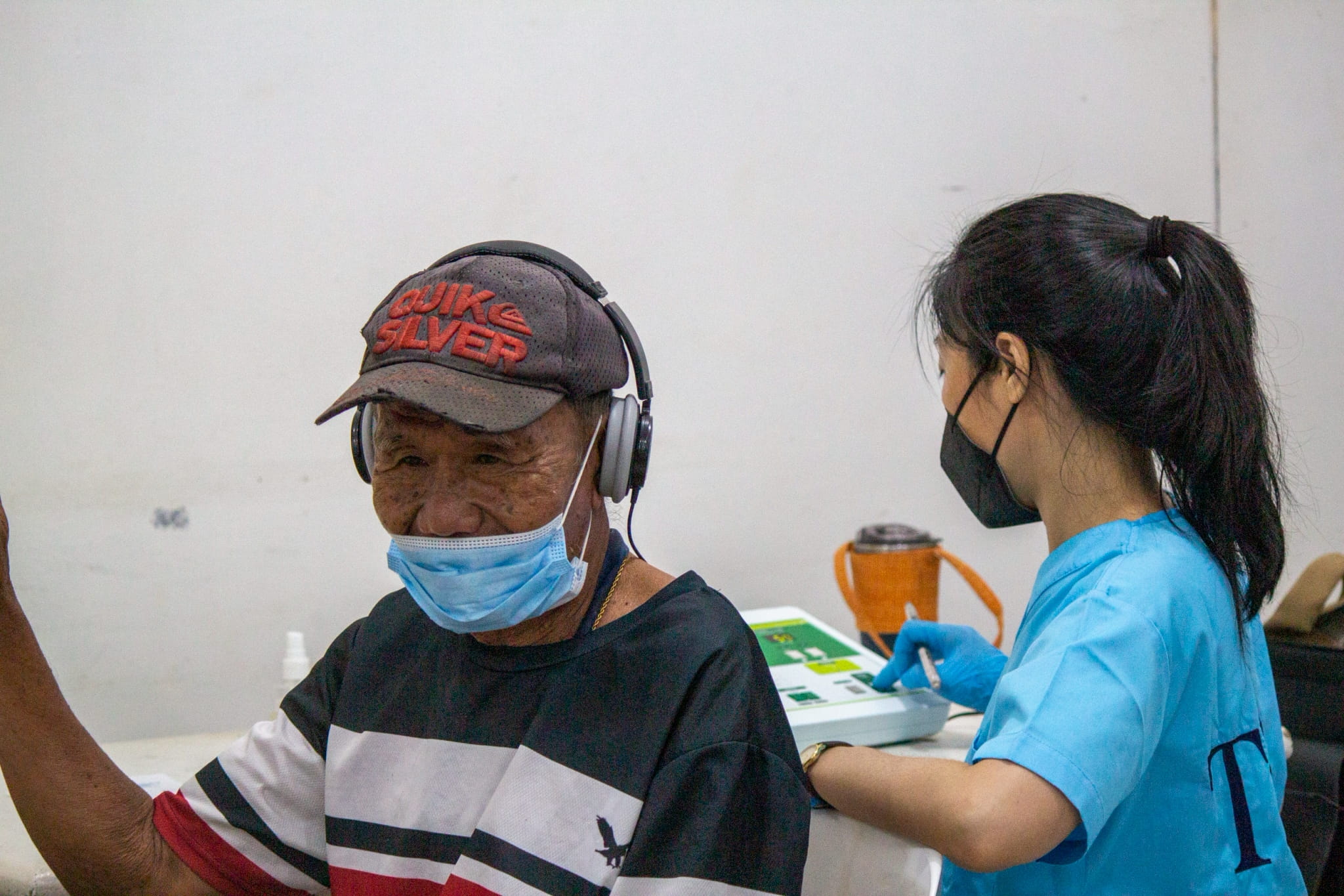 A beneficiary undergoes a hearing test before he receives a hearing aid.