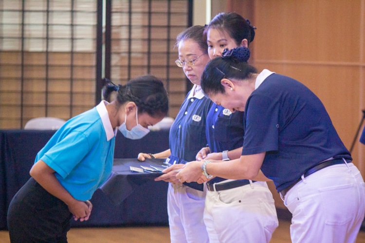 Tzu Chi Education Committee Head Rosa So presents IDs to the incoming Tzu Chi scholars.