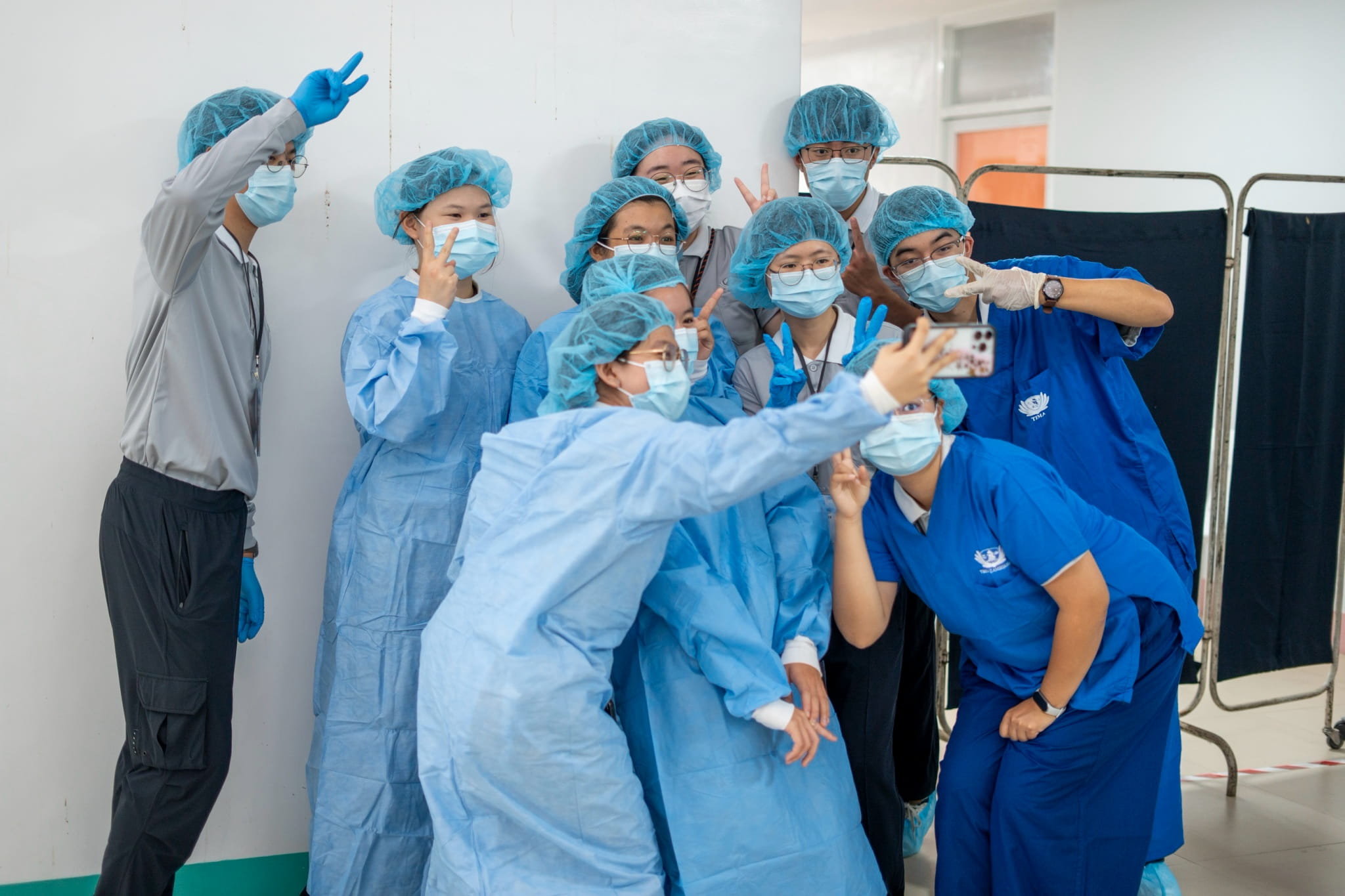 Tzu Chi University students from Taiwan poses for a group photo in their full surgical gear.