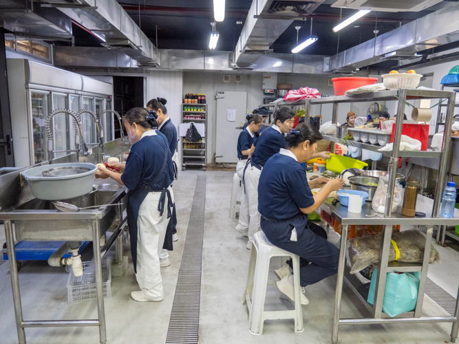 Kitchen volunteers work tirelessly behind the scenes, preparing meals with dedication and care.