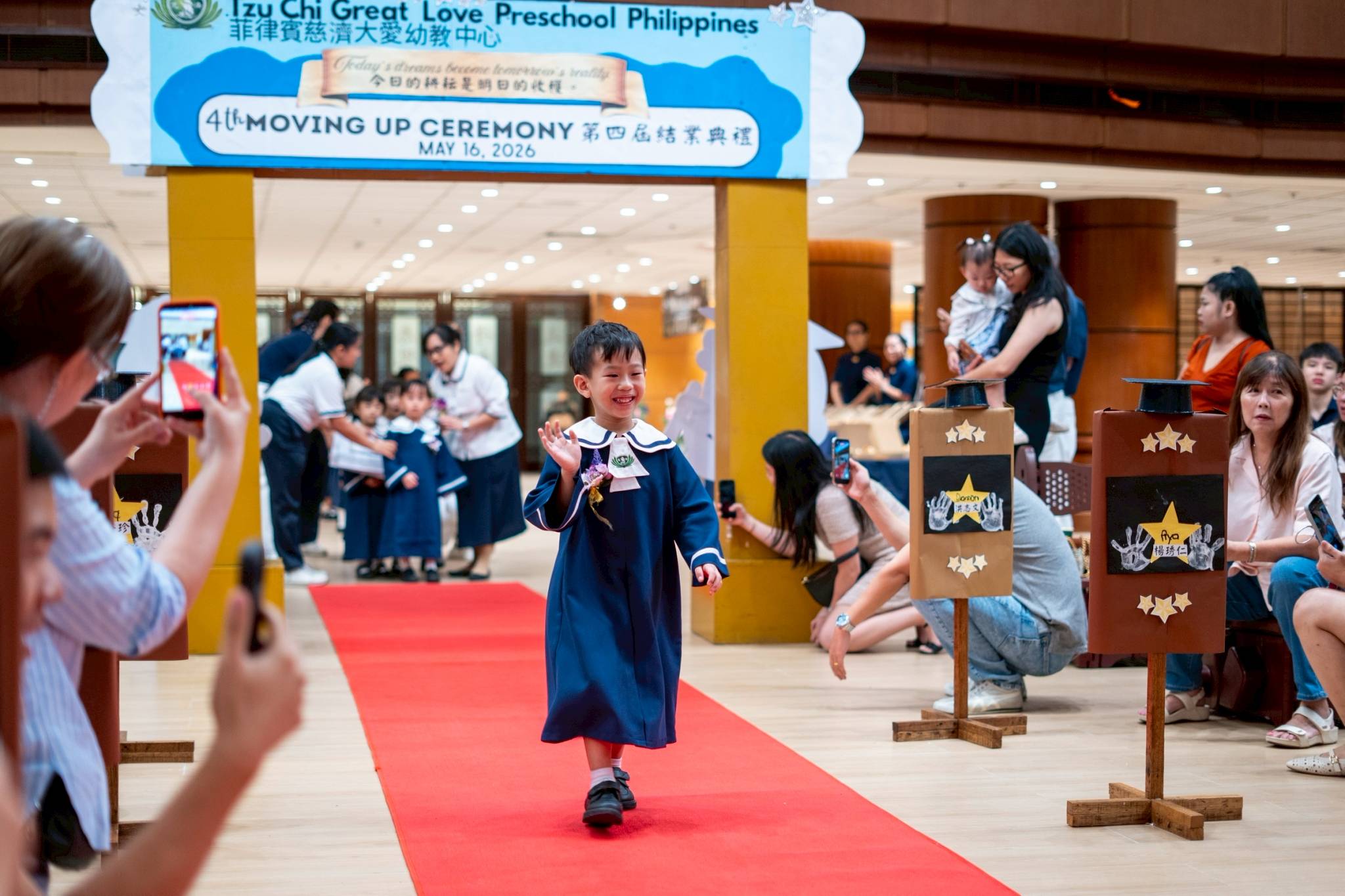 Pre-kindergarten students walk the red carpet.
