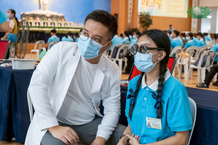 An optometrist samples different graded lenses on a scholar.