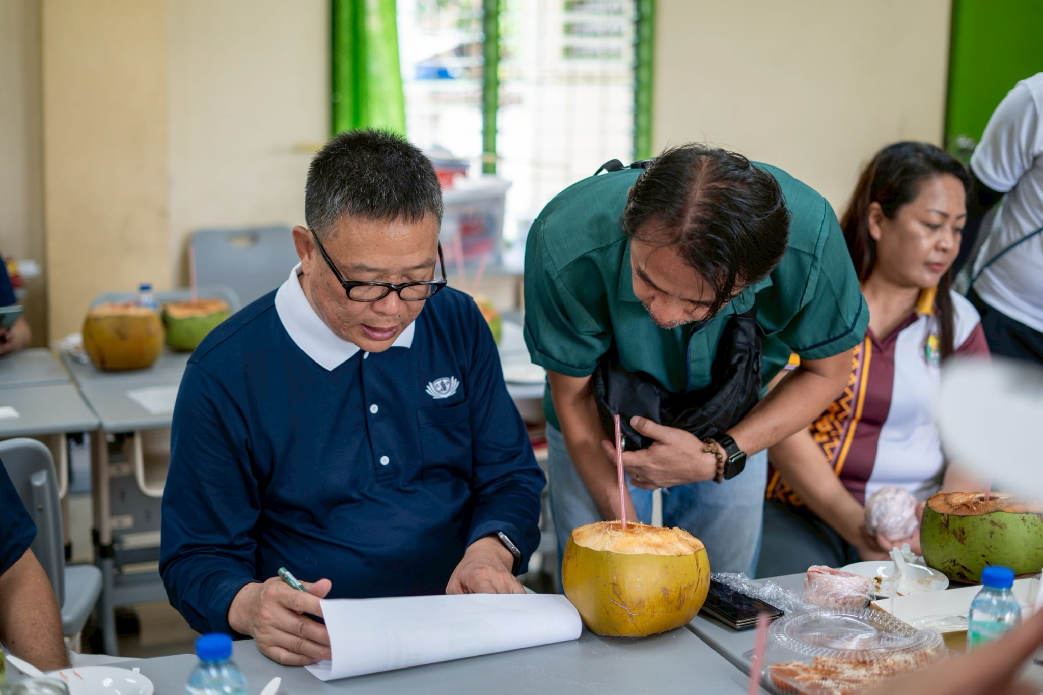 Tzu Chi Davao OIC Nelson Chua (left) and Engr. Crisanto Encarnacion assess the damage and discuss plans for possible reconstruction.