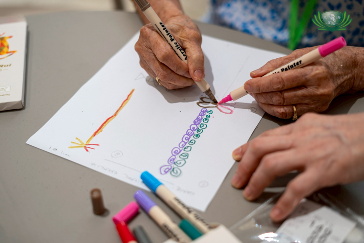 A bilateral brain gym exercise challenges seniors to draw patterns using their left and right hands.