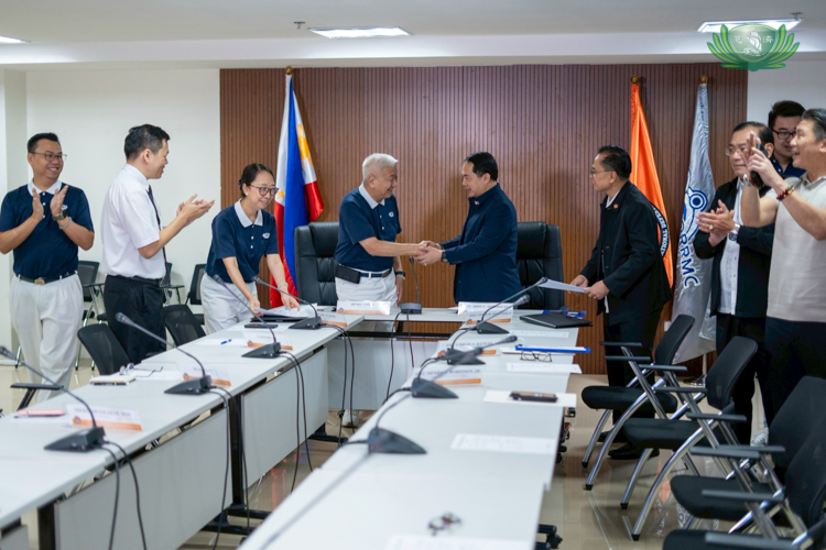 Representatives from the Office of Civil Defense and Tzu Chi Foundation Philippines applaud after a successful MoU signing.