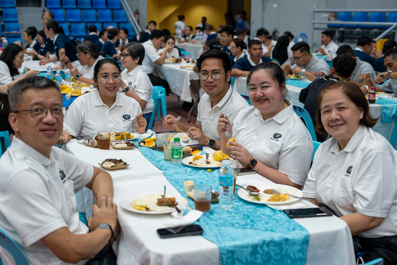 A quick pause from their meal: volunteer TIMA doctors share a smile for the camera.