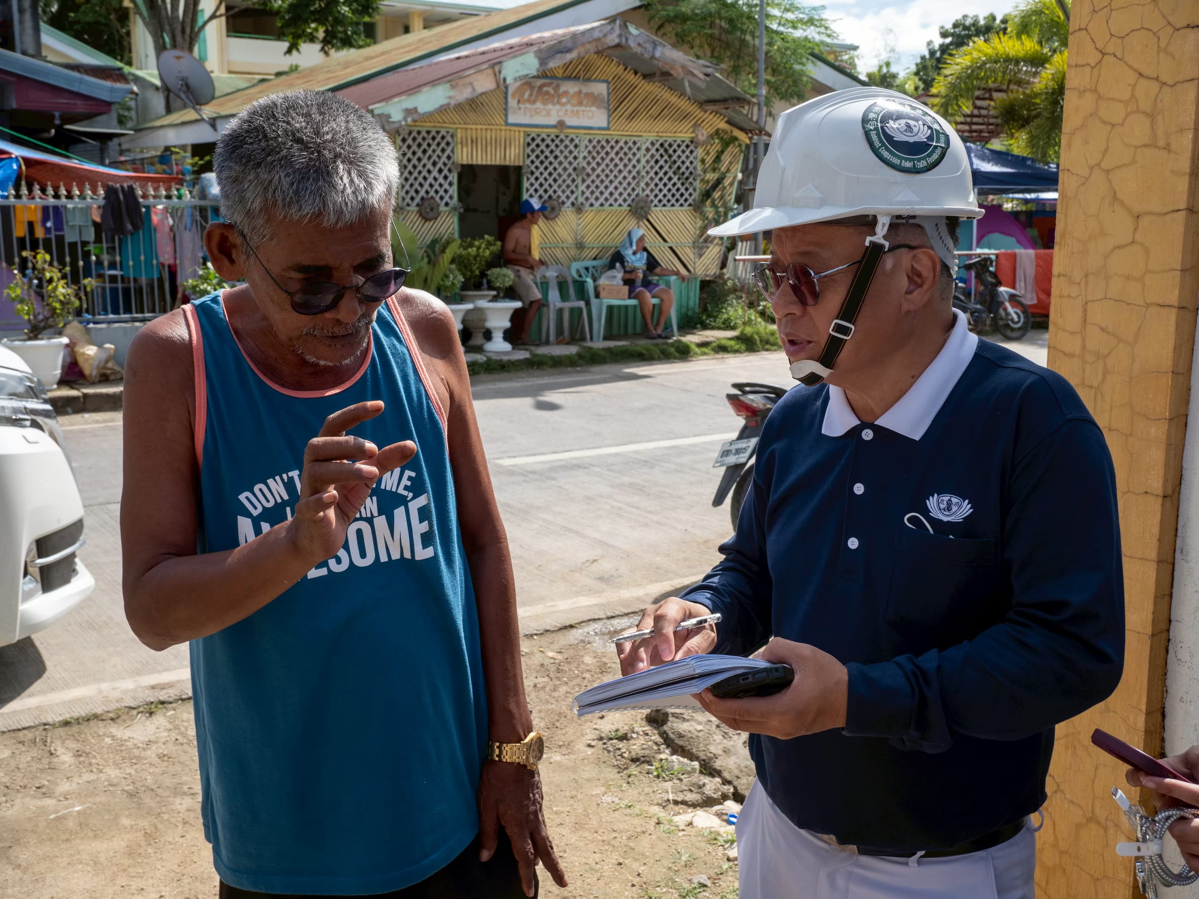 Chatting with a local at an ocular visit in Cebu following a magnitude 6.9 earthquake in September 2025.