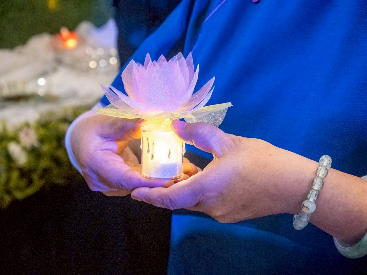 The lotus candles signify a commitment to spiritual devotion and a common goal of bringing more harmony and peace to the world.