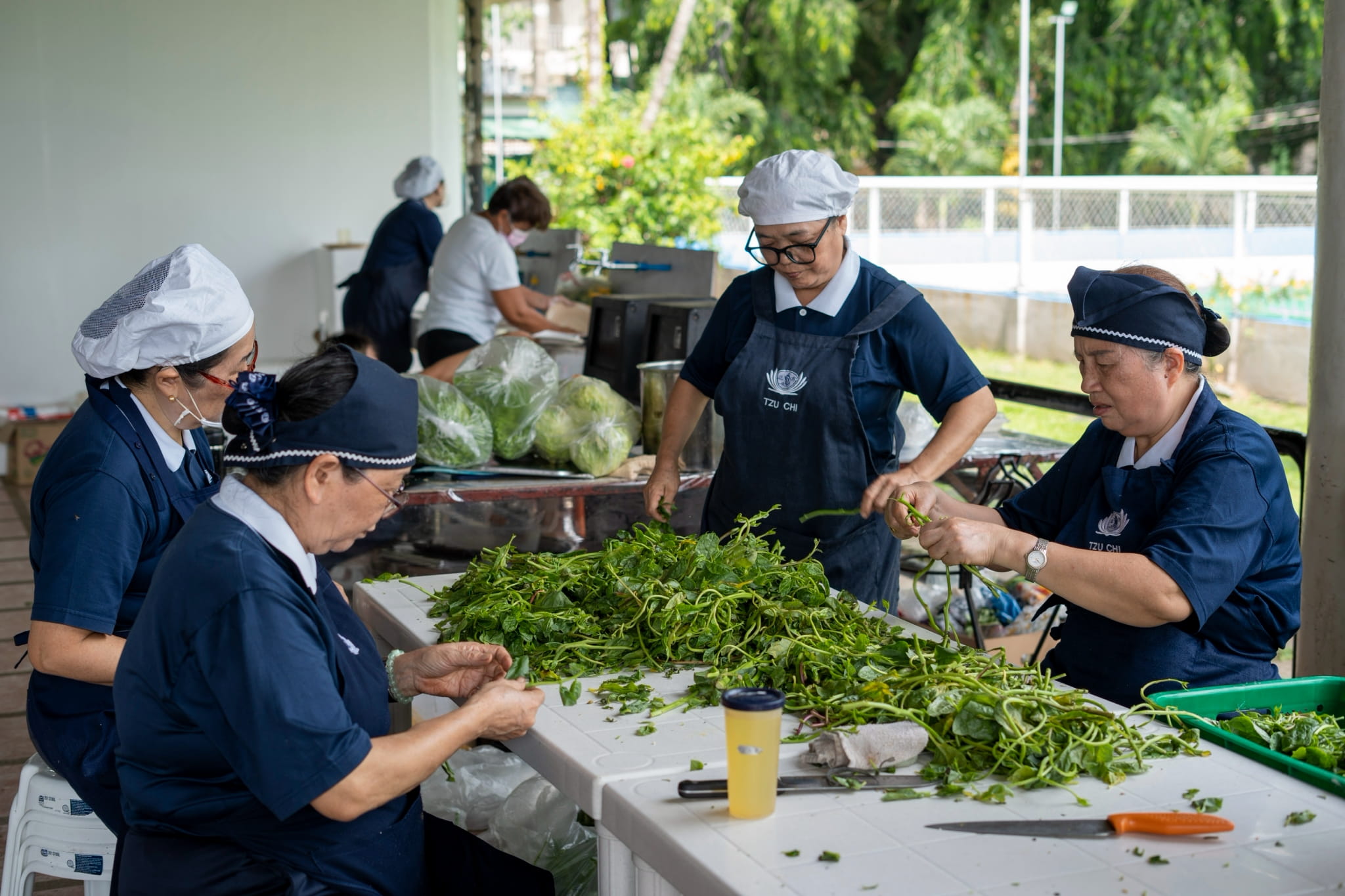The kitchen team works tirelessly preparing delicious meals that keep everyone fueled and ready to serve.