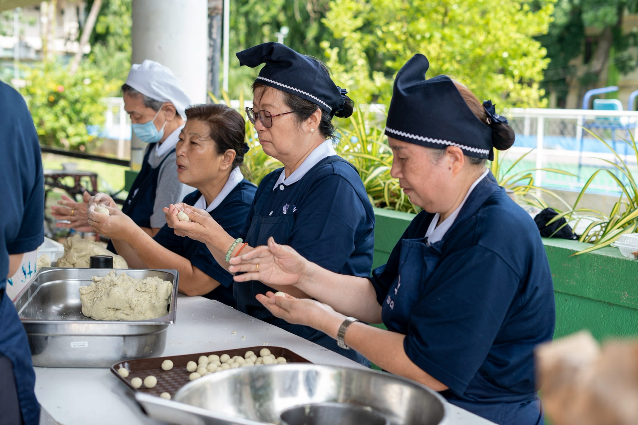 The kitchen team works tirelessly preparing delicious meals that keep everyone fueled and ready to serve.