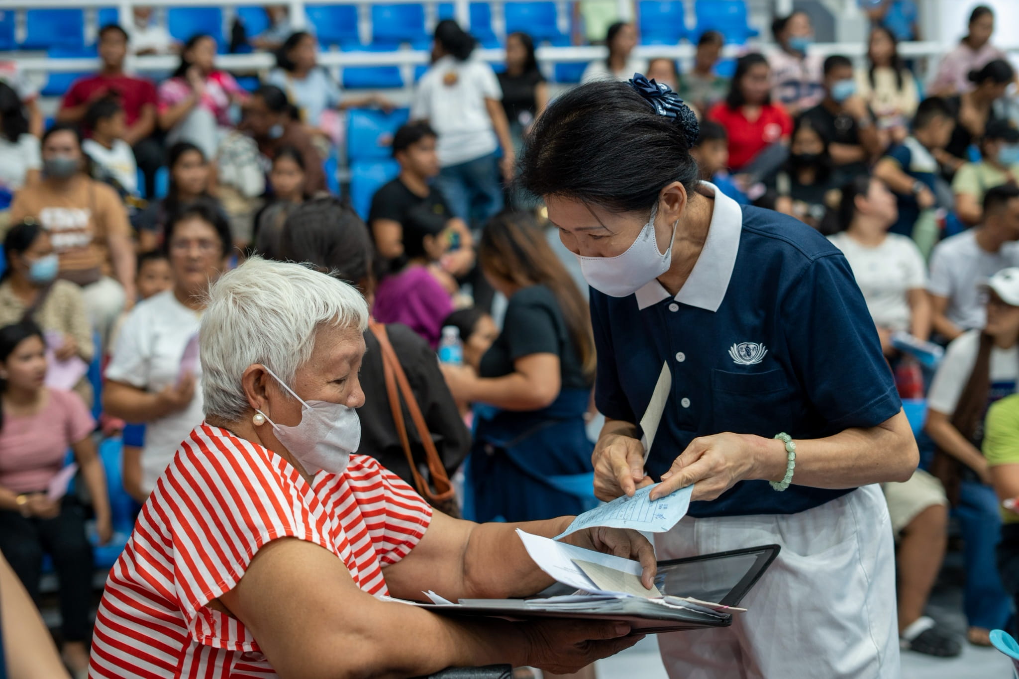 Tzu Chi volunteers tirelessly assist patients throughout the medical mission.