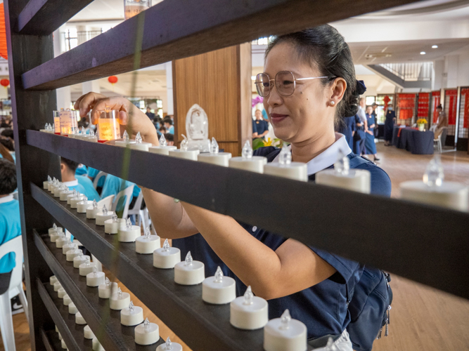 At the entrance of Jing Si Auditorium, guests and volunteers are invited to write down their wishes for the new year, encase them in battery-operated votive candles, and place them on a shelf.