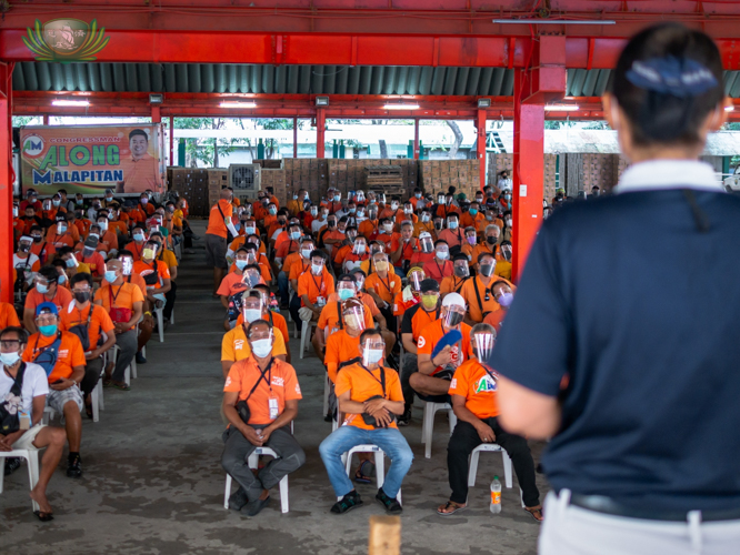 A Tzu Chi volunteer addresses a full house of tricycle drivers at Caloocan High School. 【Photo by Daniel Lazar】