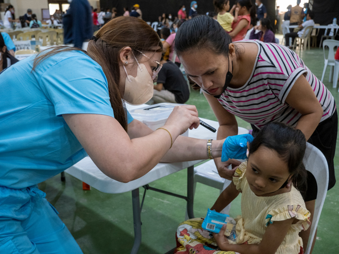 A pediatric patient receives a full consultation.