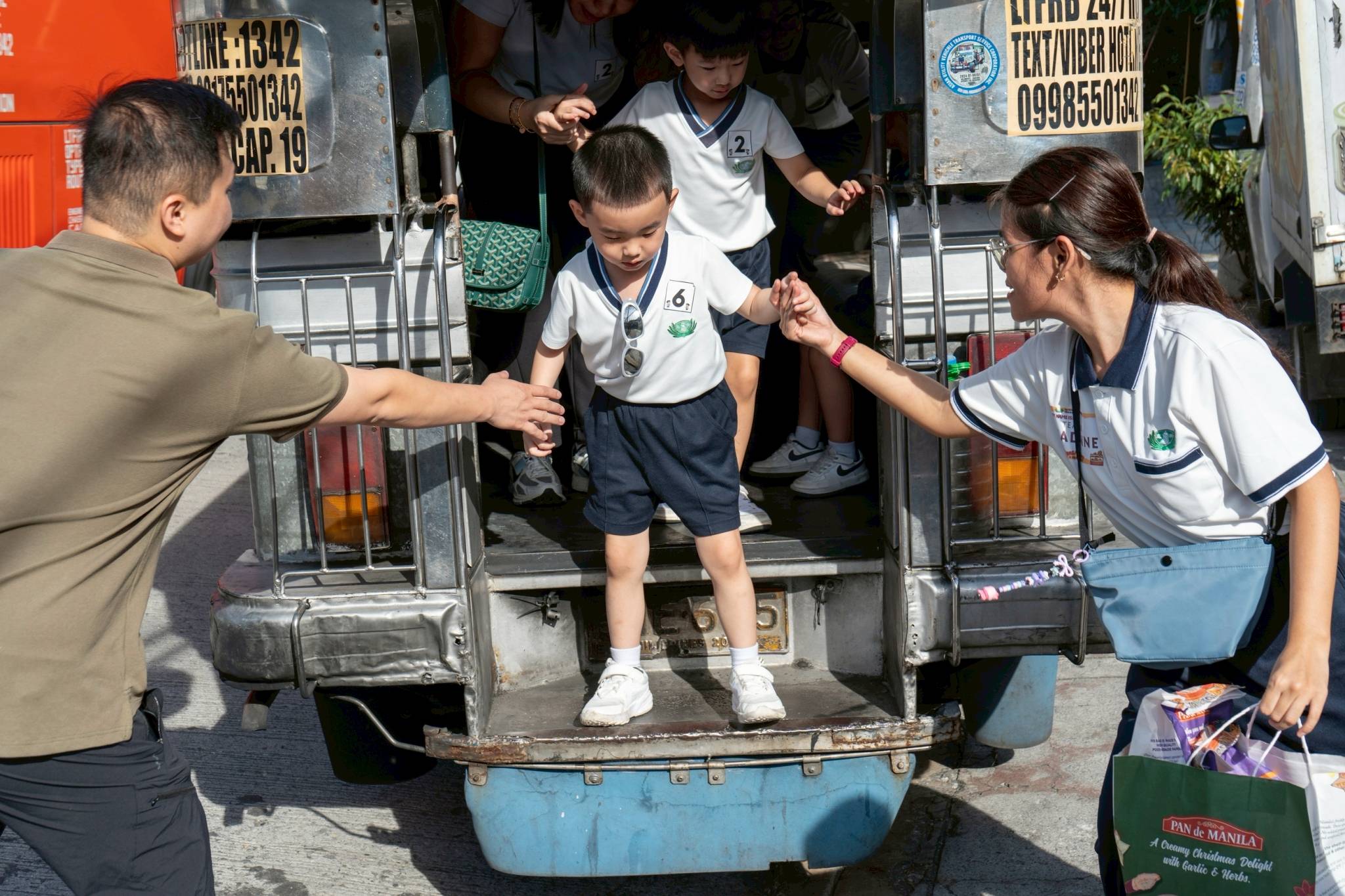 Students exit the jeepney upon arriving at the nearby bread shop. 