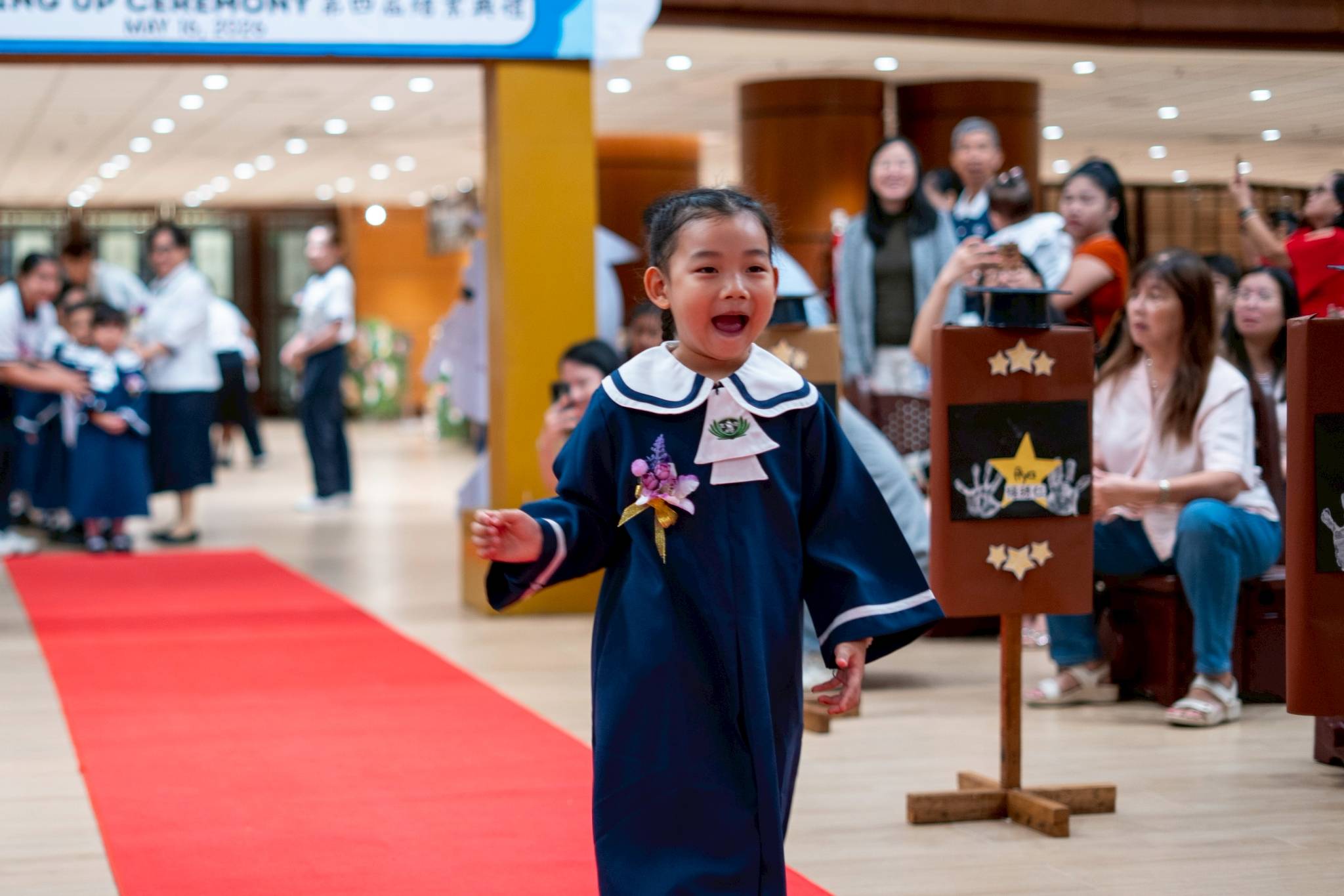 Pre-kindergarten students walk the red carpet.
