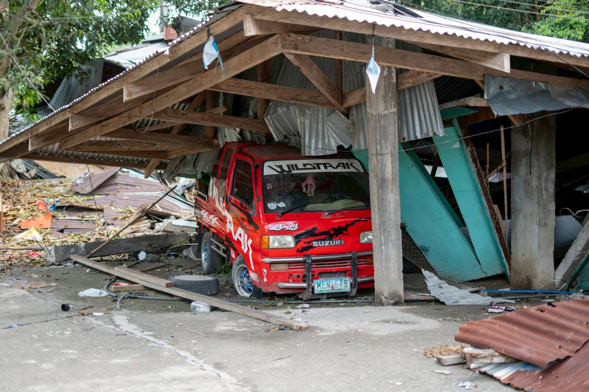A pickup truck is crushed by the weight of a collapsed garage roof. 