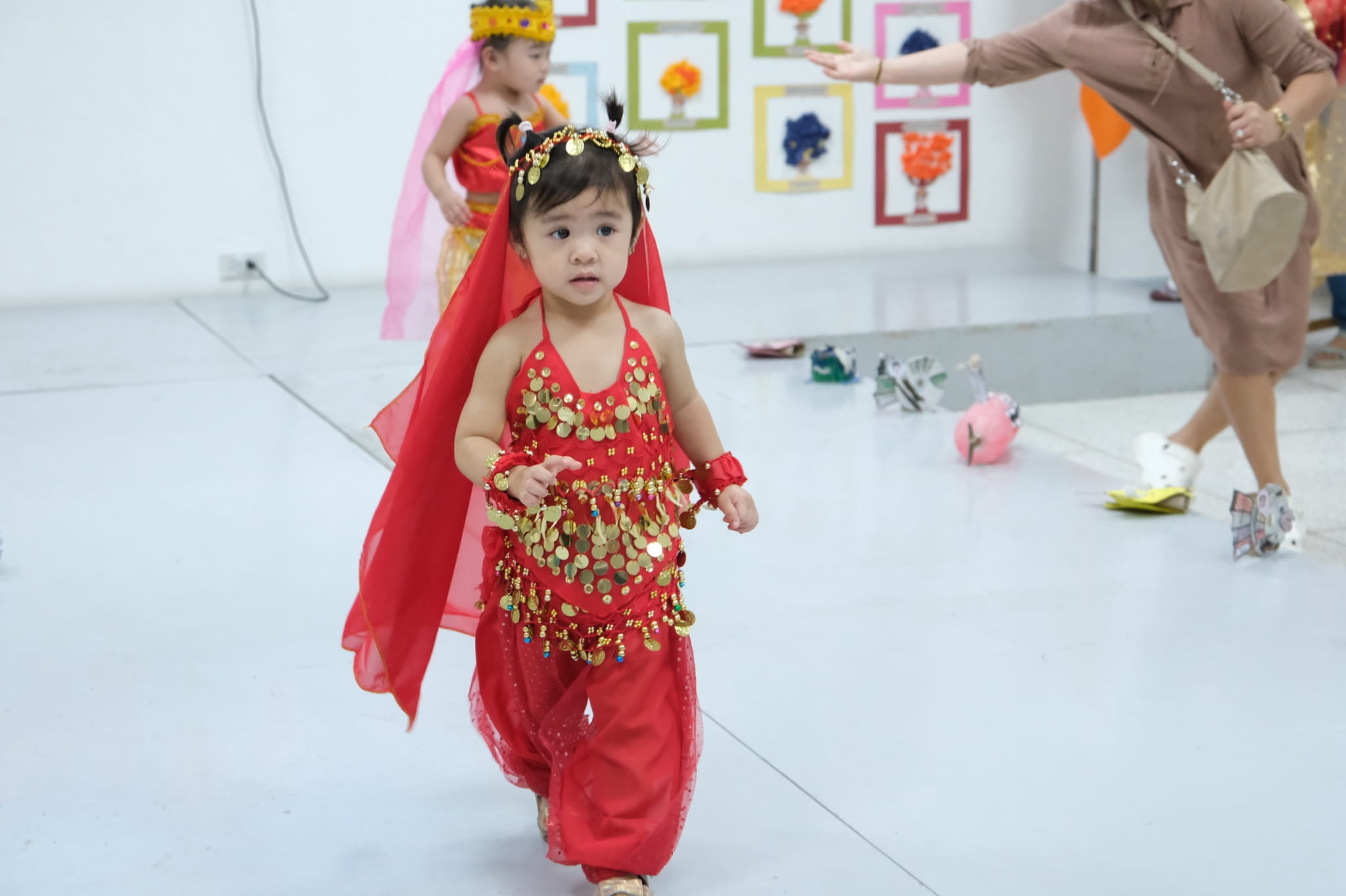 Preschoolers steal the spotlight in their colorful traditional costumes.