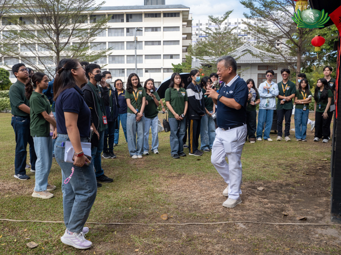 Tzu Chi volunteer Johnny Kwok explains the significance of the wooden cabin, a replica of the one Dharma Master Cheng Yen lived in  during her beginnings as a Buddhist Nun.