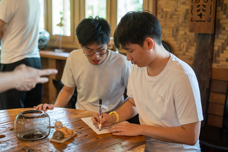 At the Creative Drawing Relay station, team members have just five seconds each to contribute to a collaborative artwork before passing the paper to the next person.