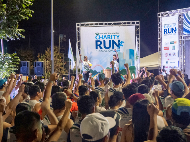 Charity Run hosts Jane Sy and Spencer Sze hype the runners while highlighting the cause of the run.
