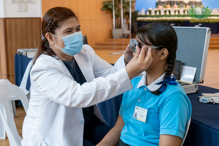 An optometrist samples different graded lenses on a scholar.