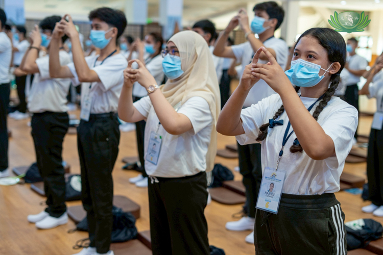 Back at the Tzu Chi campus, scholars are taught hand gestures that reflect Tzu Chi culture and principles.