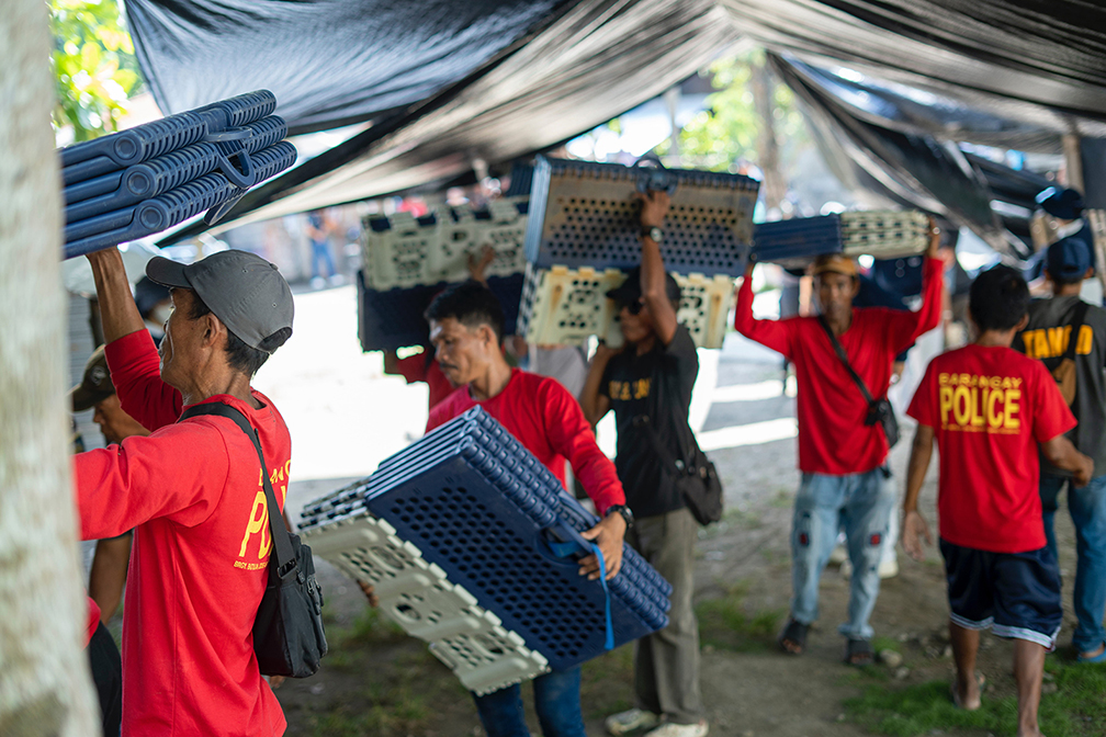 Jose Abad Santos volunteers unload Tzu Chi’s folding beds for distribution to households with totally damaged homes. 