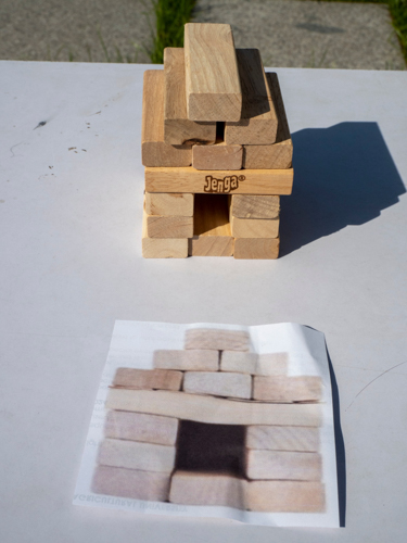 Jenga blocks are used to help build a model of the Jing Si Abode. 