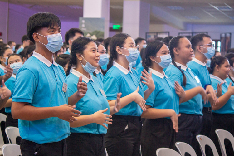 Tzu Chi scholars practice the sign language for the song “One Family.”  