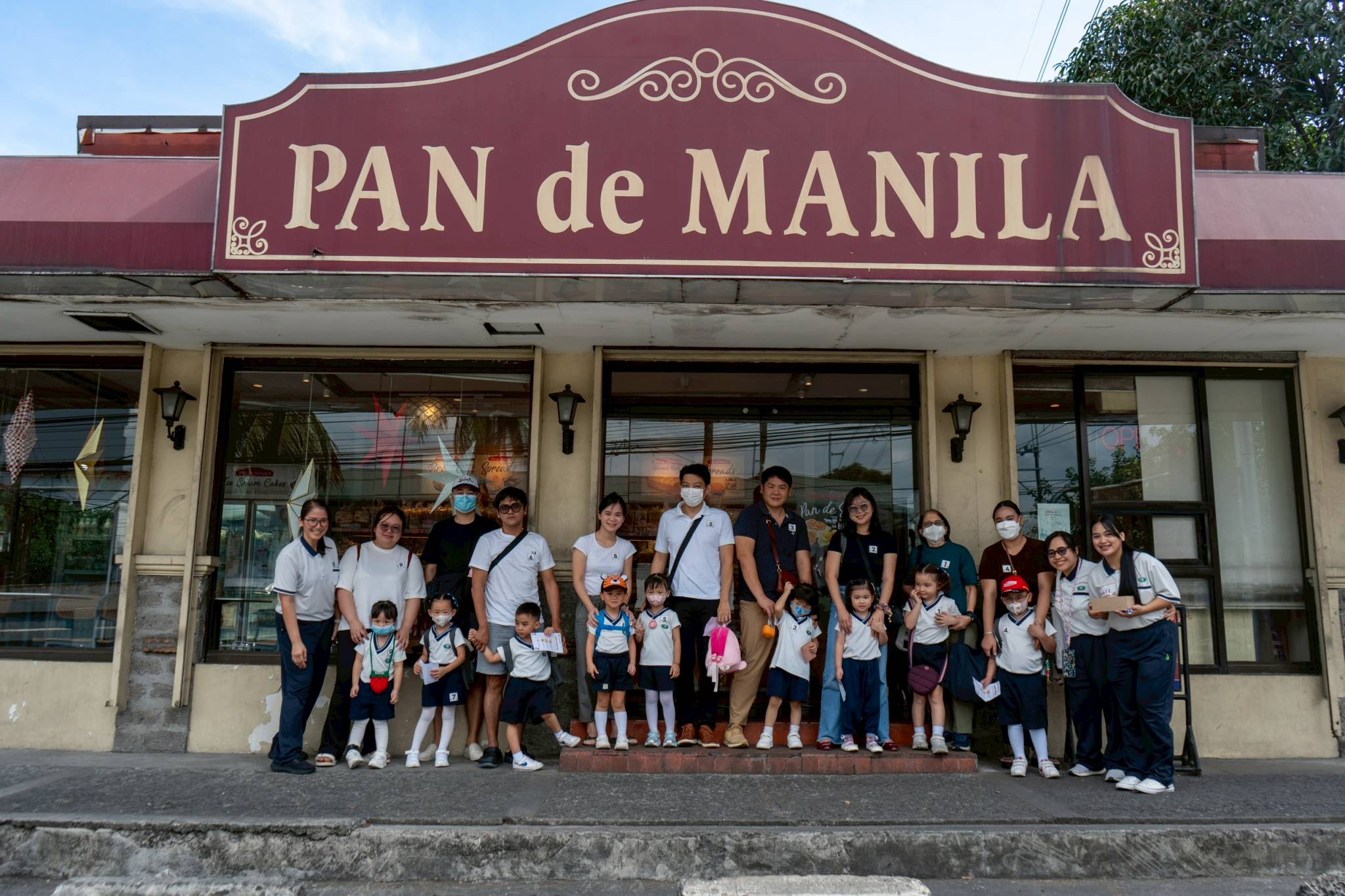Together with their parents, the students posed for a photo in front of Pan de Manila before buying bread and pastries.