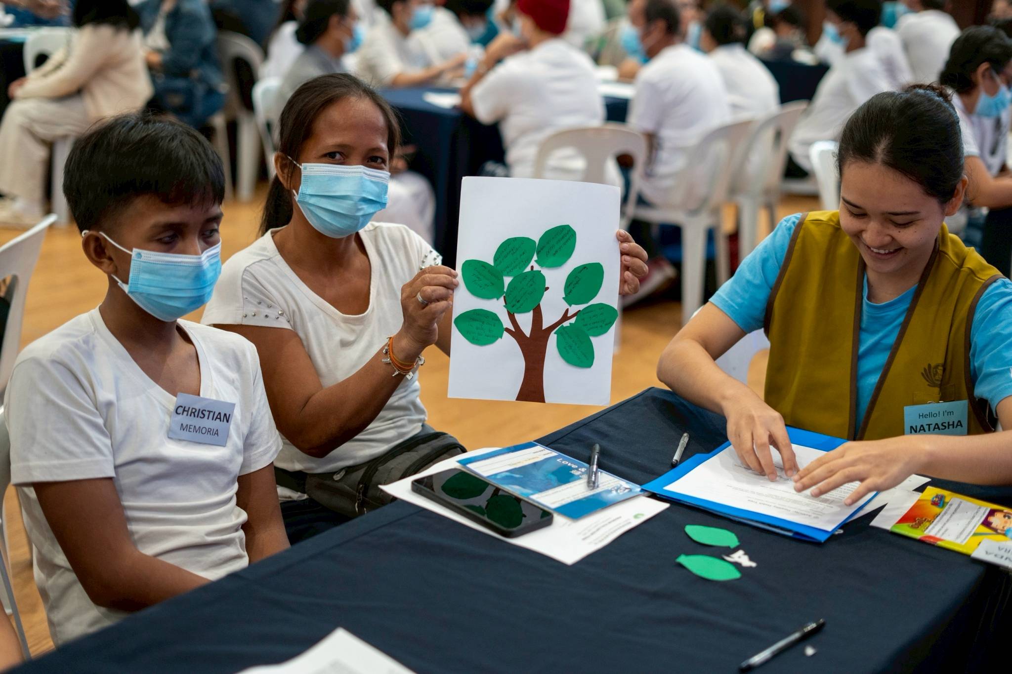 In the group activity “Healthy Habit Tree,” medical assistance beneficiaries write the healthy habits they practice or want to start practicing on a leaf-shaped paper.