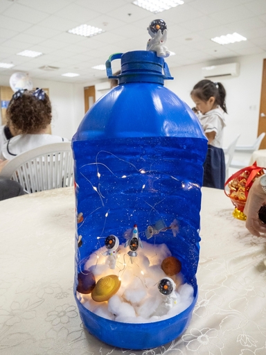 Michelle Fang and daughter Olivia Lai’s lantern was made from leftover materials such as cotton, plastic bottle, and small astronauts and planets decorating the piece.