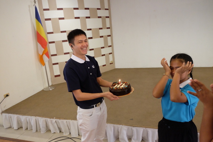 Tzu Chi Zamboanga Vice OIC Harvey Yap (left) surprises scholar Rosevic Cabaral with a cake for her birthday. 