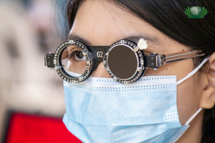 An optometrist samples different graded lenses on a scholar.