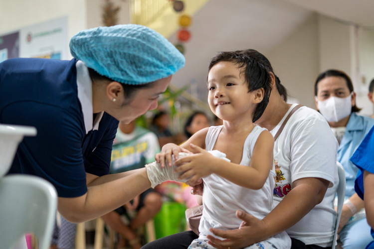 In a show of compassion, Tzu Chi volunteers help clean patients up post-surgery.