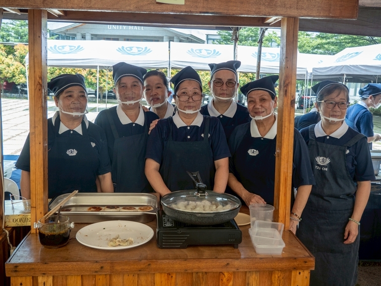 Volunteers prepare savory Chinese dumplings.