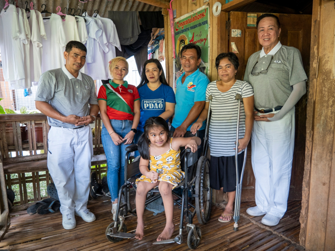 Tzu Chi volunteers conduct a home visit with Arlyn Segarra (second from right, in crutches) before the Jaipur Foot Camp on May 16.