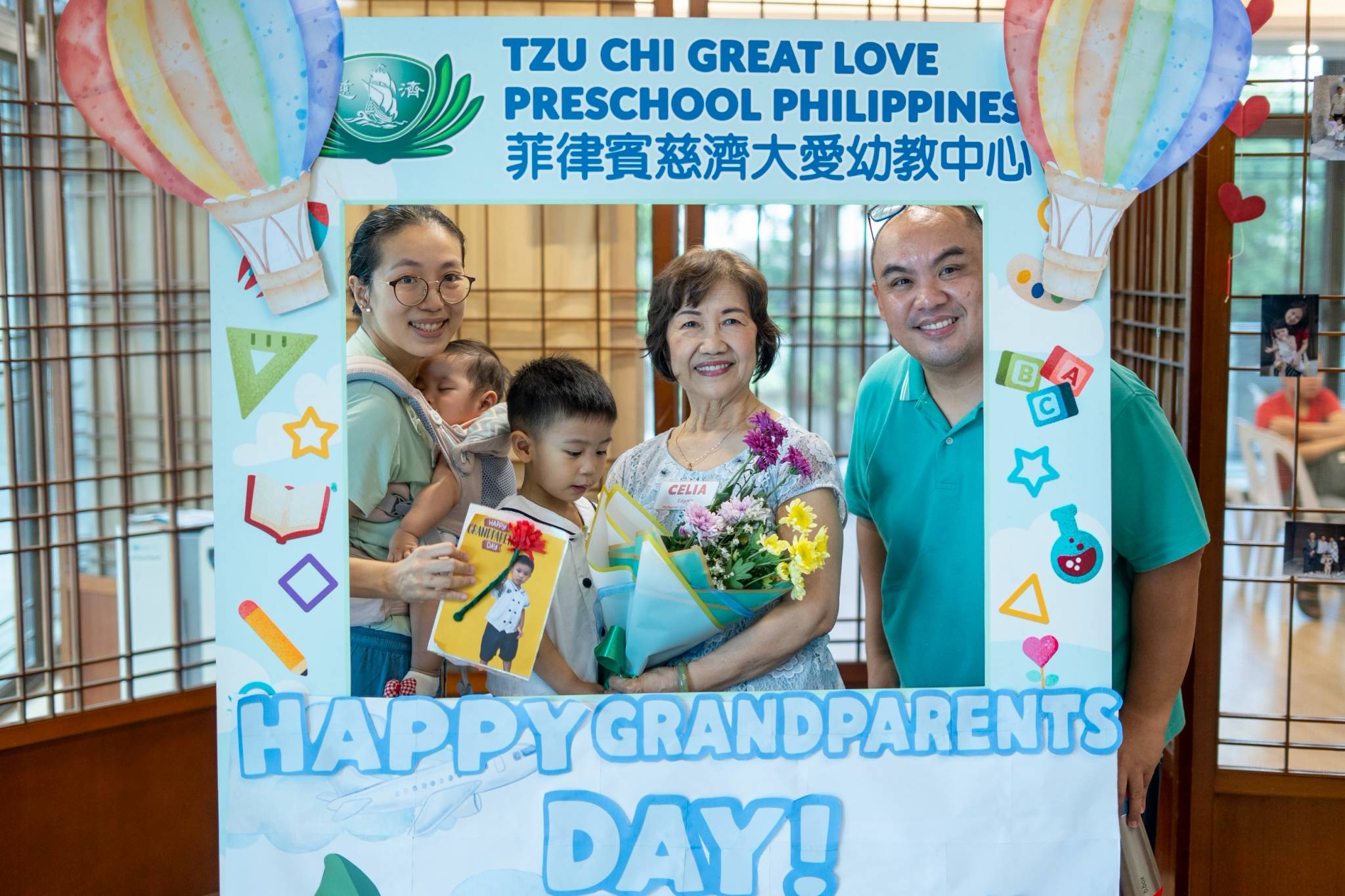 Smiles all around as families strike a pose inside the custom photo frame cutout.