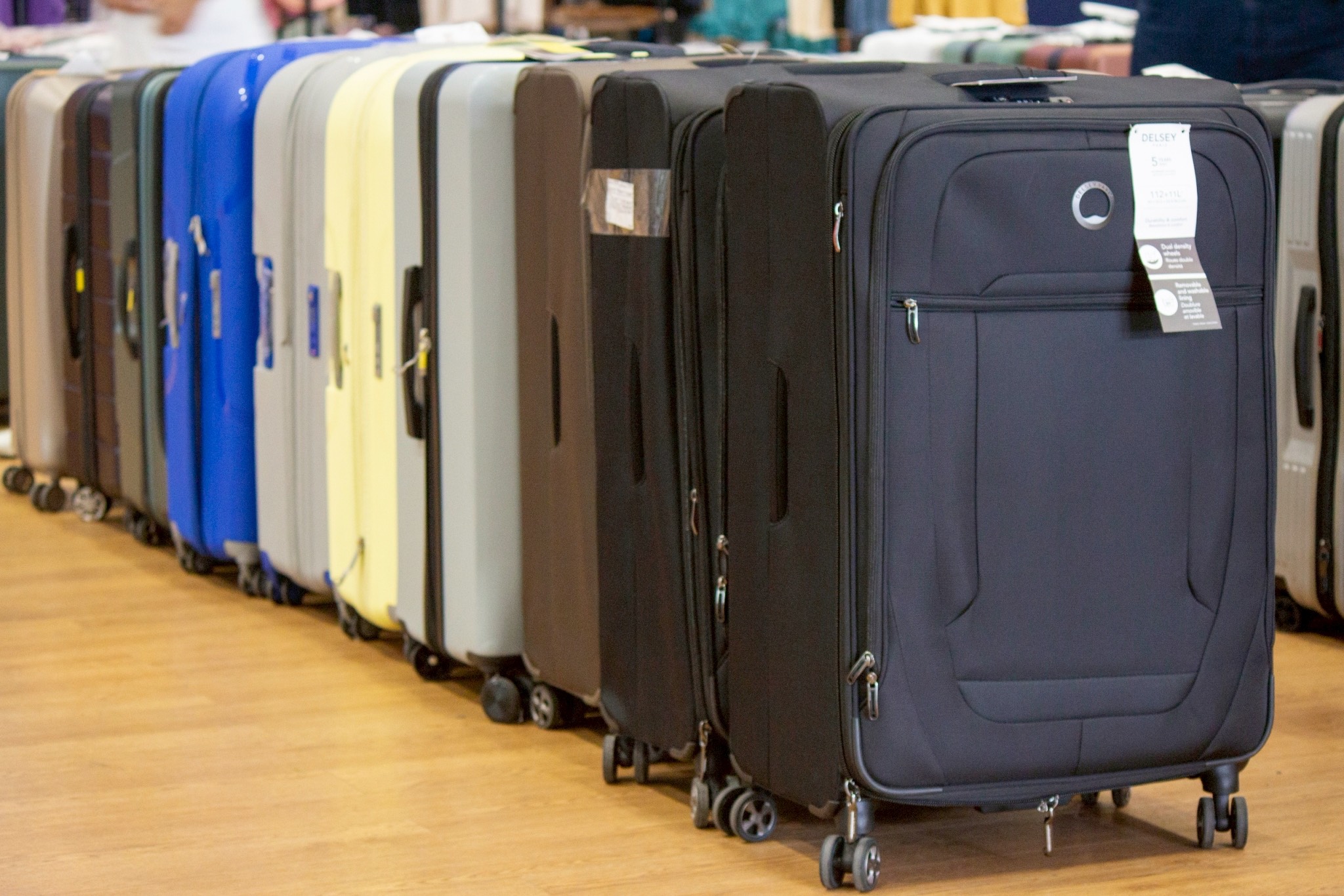Rows of colorful suitcases await travelers looking for a deal at the Tzu Chi bazaar.